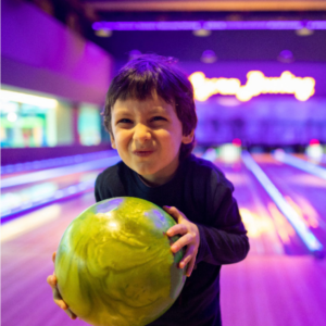 Child goes bowling at Gutterball